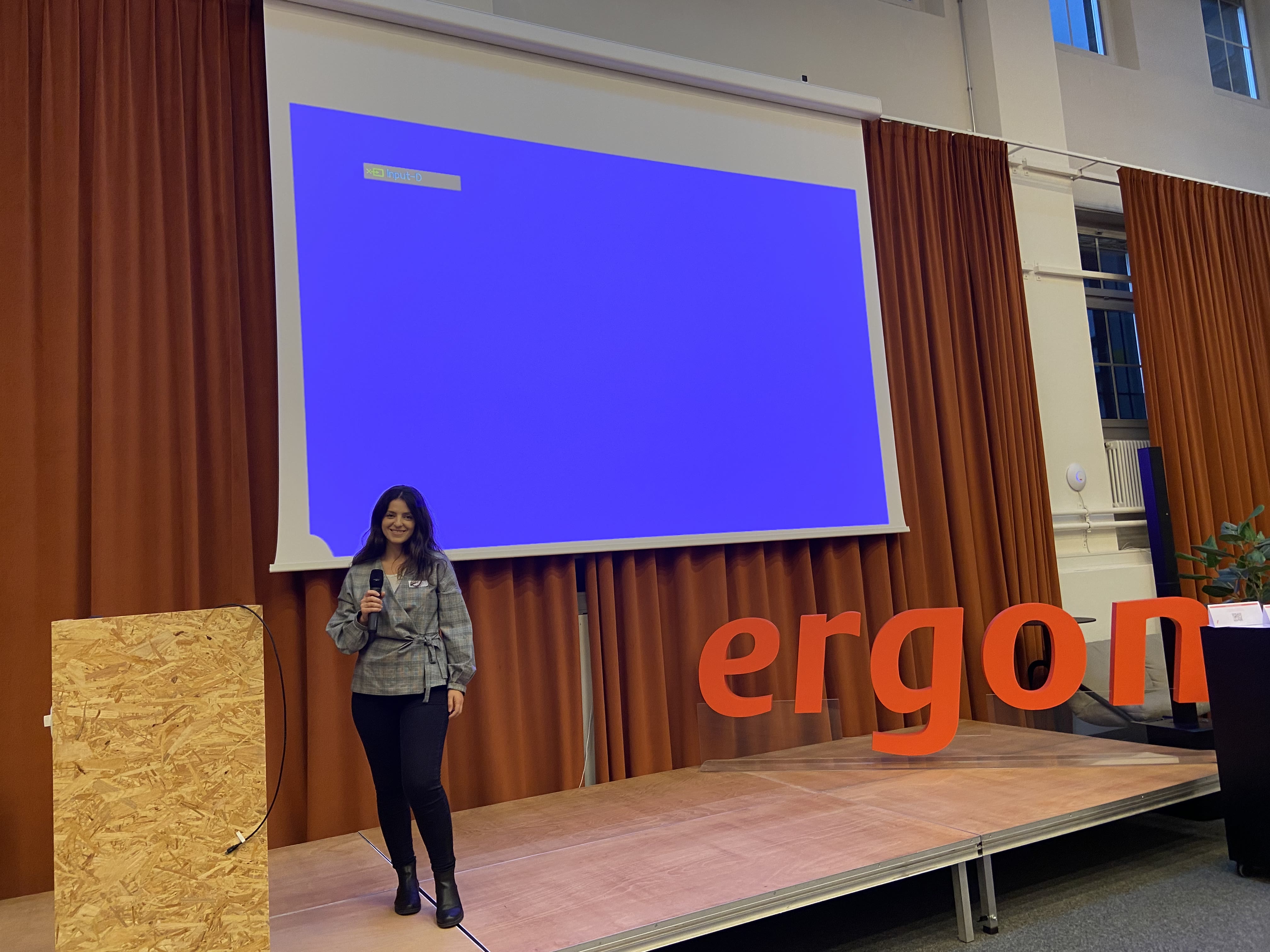 Nur Memeti presenting on stage